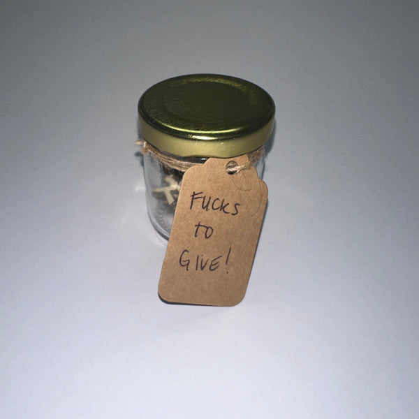 Glass jar of wood words cut out to say FUCK