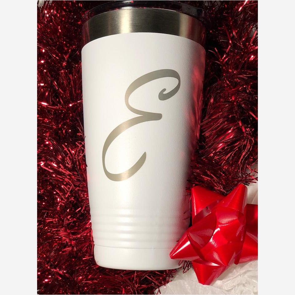 20 oz. white stainless steel tumbler with silver ring at top grips on bottom engraved with "E"