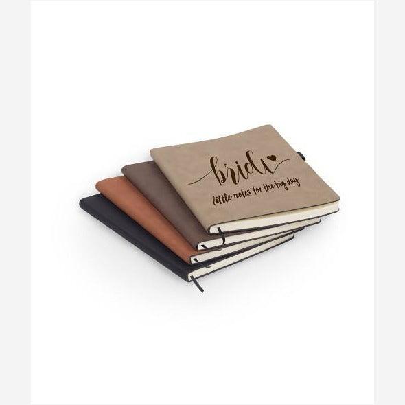Stack of black, light brown, dark brown, tan leatherette journals