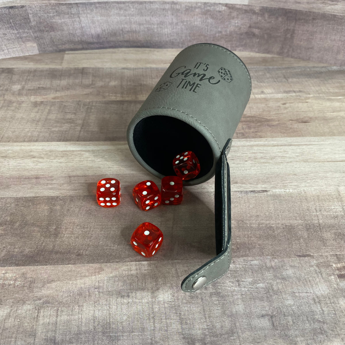 gray dice cup on side showing dice storage in the bottom